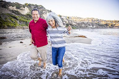 Senior-Hispanic-Couple-Walking-Along-the-Beach